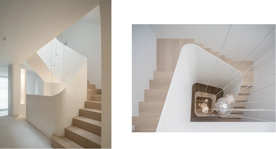 Modern, minimalist interior with wooden stairs and minimalist lighting.