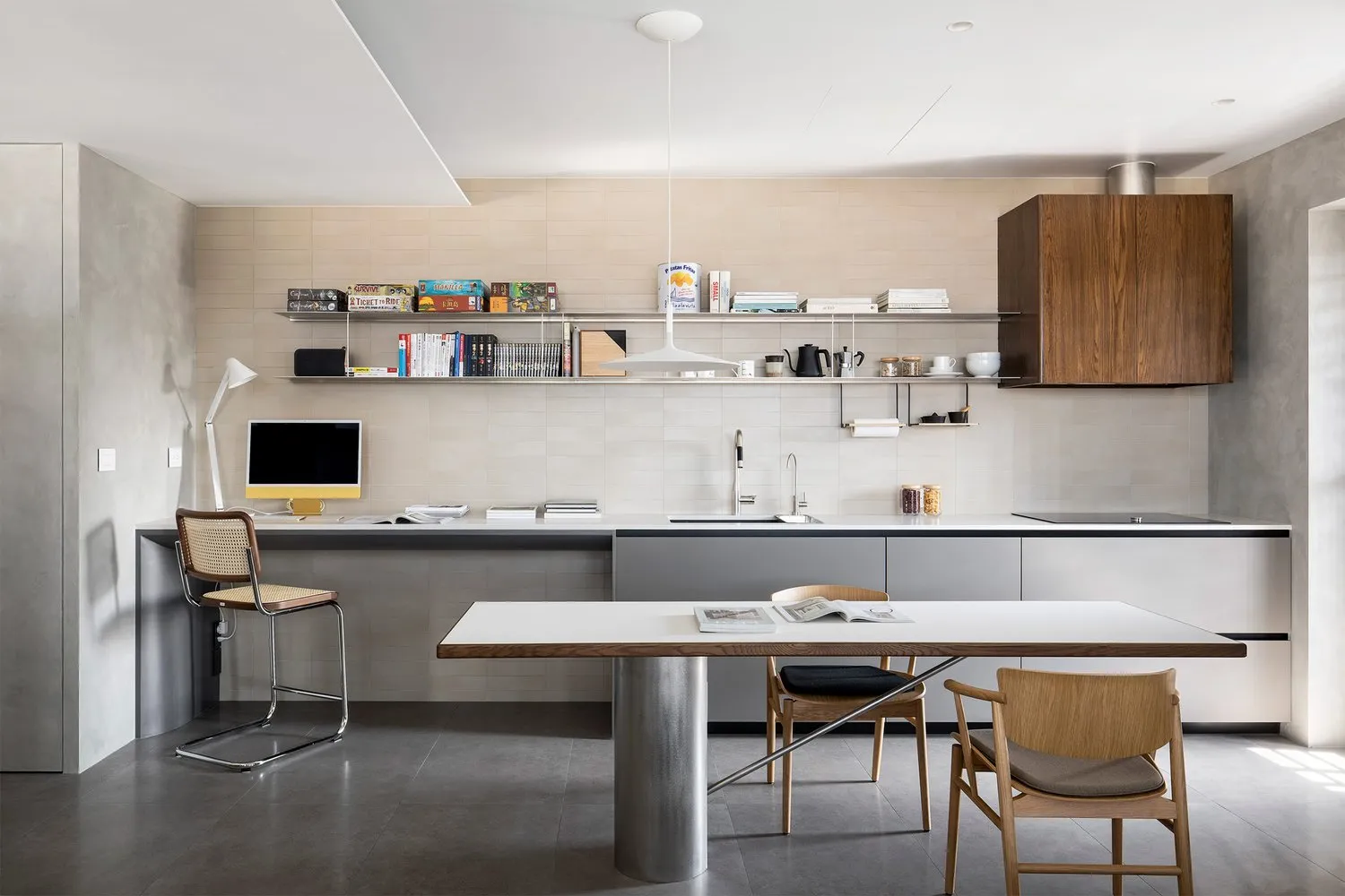 Modern minimalist kitchen with concrete, wood, and metal materials.