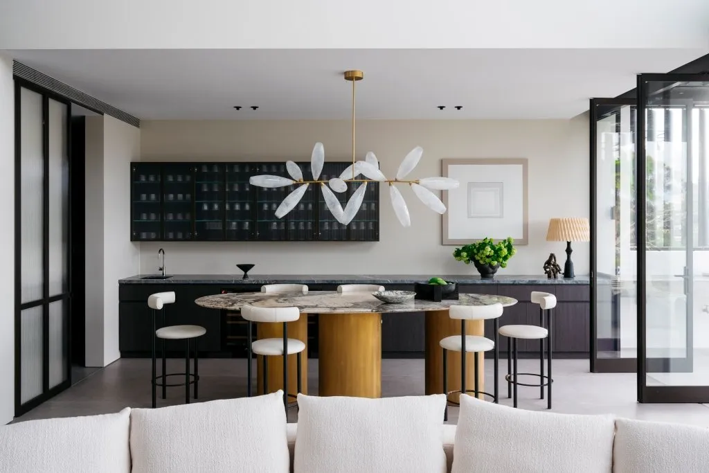 Modern kitchen featuring marble countertops and concrete finishes