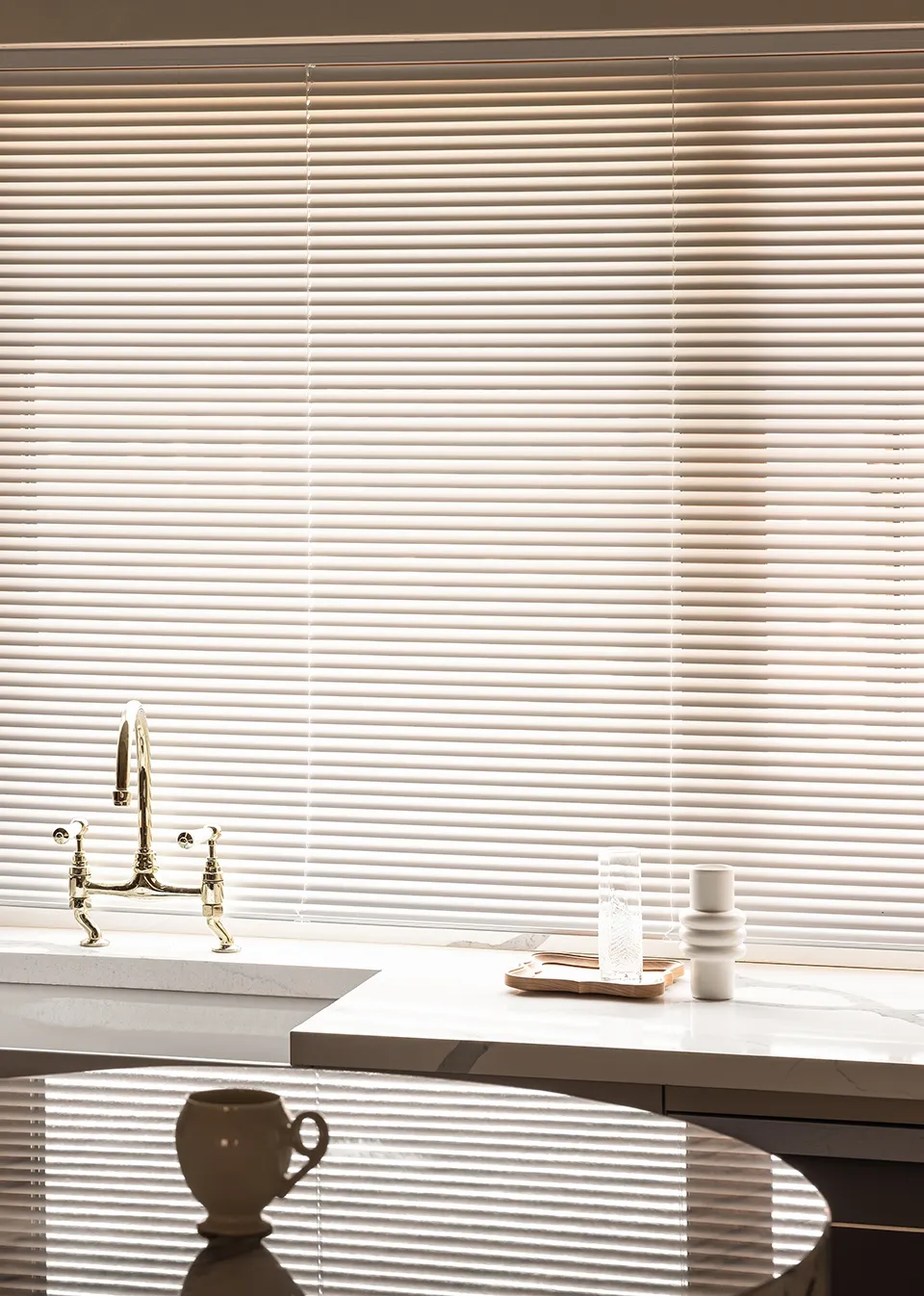 A modern minimalist kitchen featuring marble countertops and a sleek, sophisticated design.