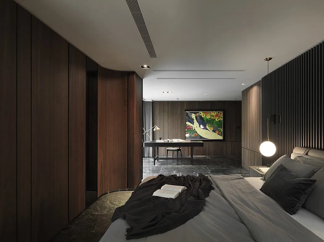A modern bedroom featuring wooden walls, a grey bed, and a light fixture