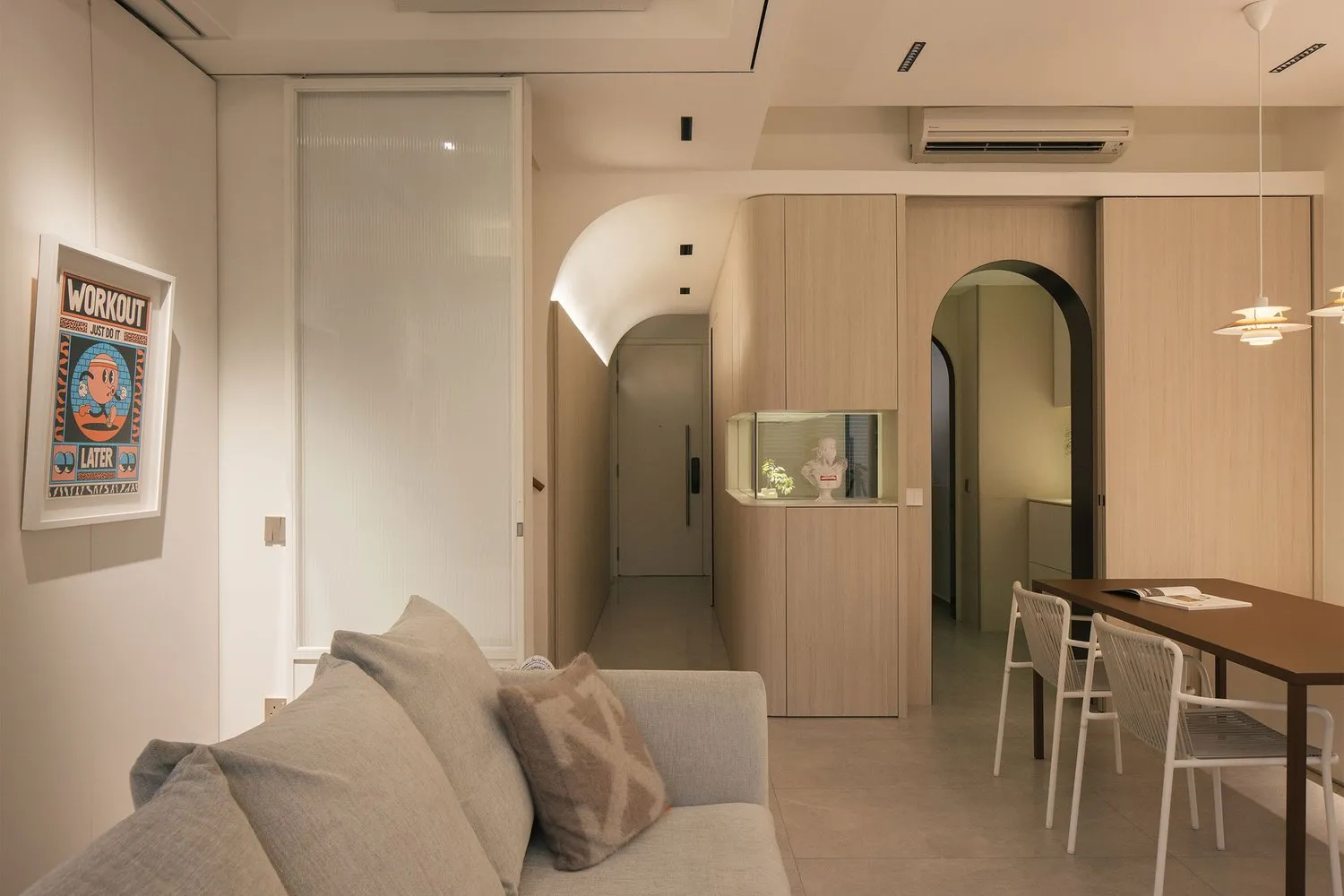 A modern, minimalist living room with neutral-toned furniture and decor.