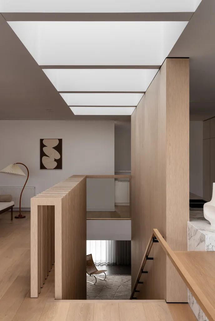 Modern minimalist residential staircase featuring wooden panels and marble elements.