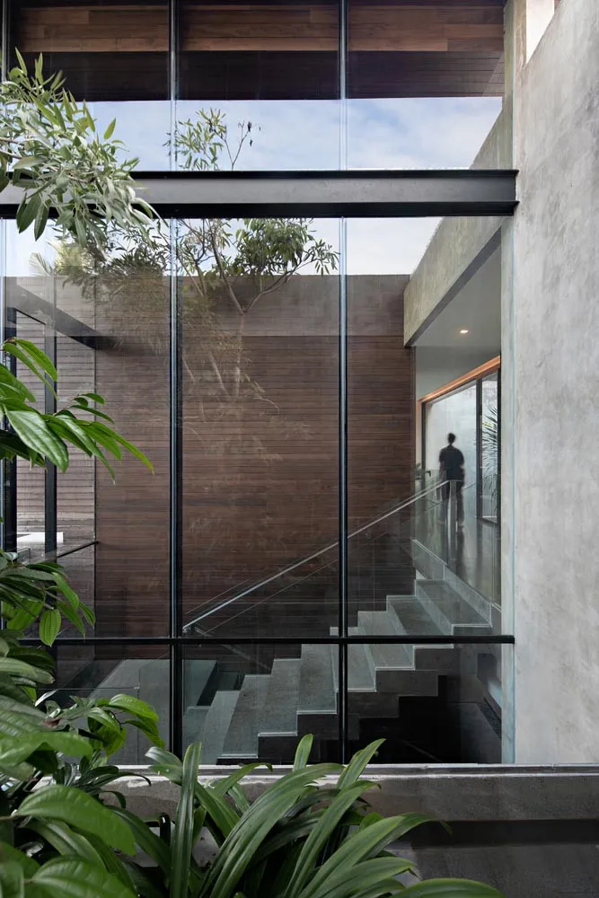 Modern staircase with glass panels and concrete steps