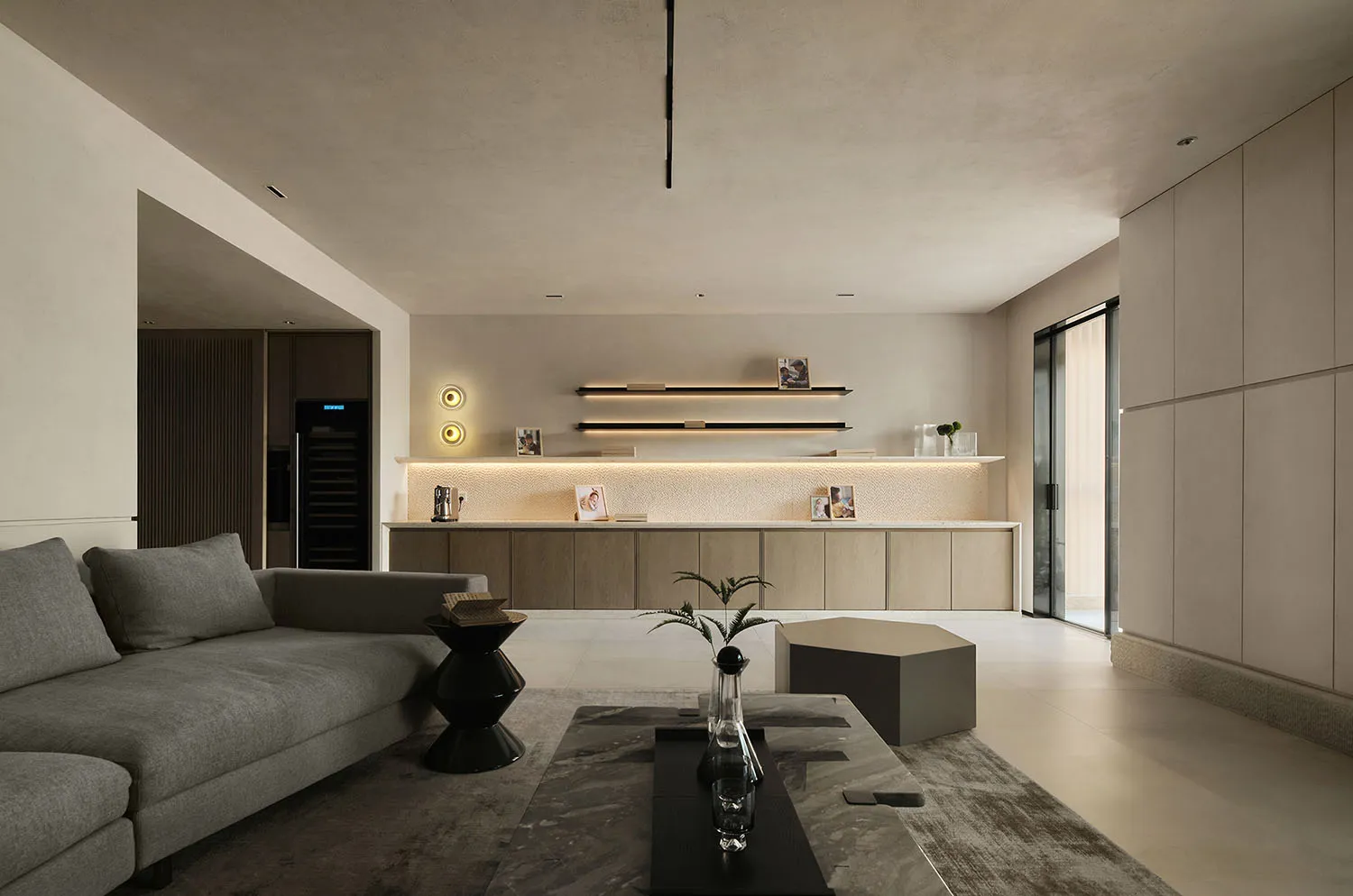 A modern living room featuring concrete flooring, wooden accents, and minimalist design elements.