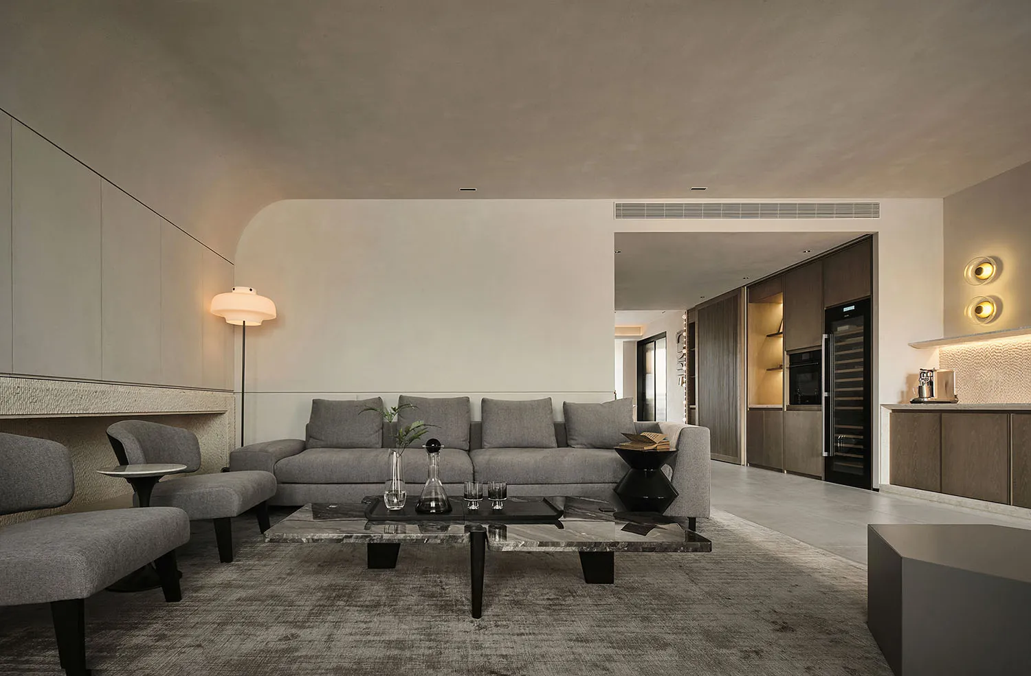 Modern living room featuring a gray fabric sofa, wooden cabinets, and a marble coffee table.