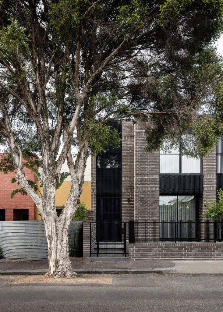A modern house with brick exterior and large windows.