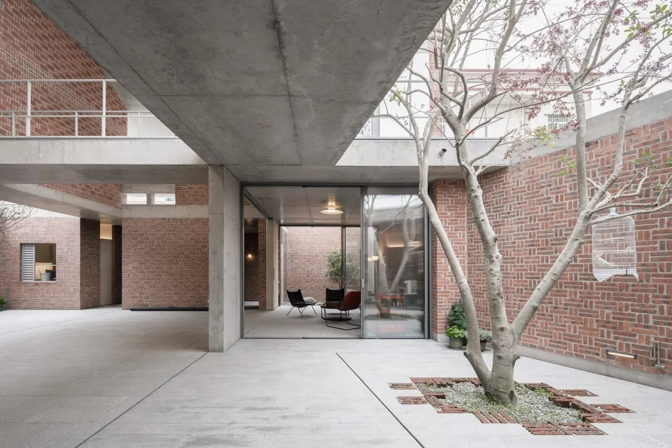 Modern indoor garden featuring brick and concrete structures, minimalist design with plants
