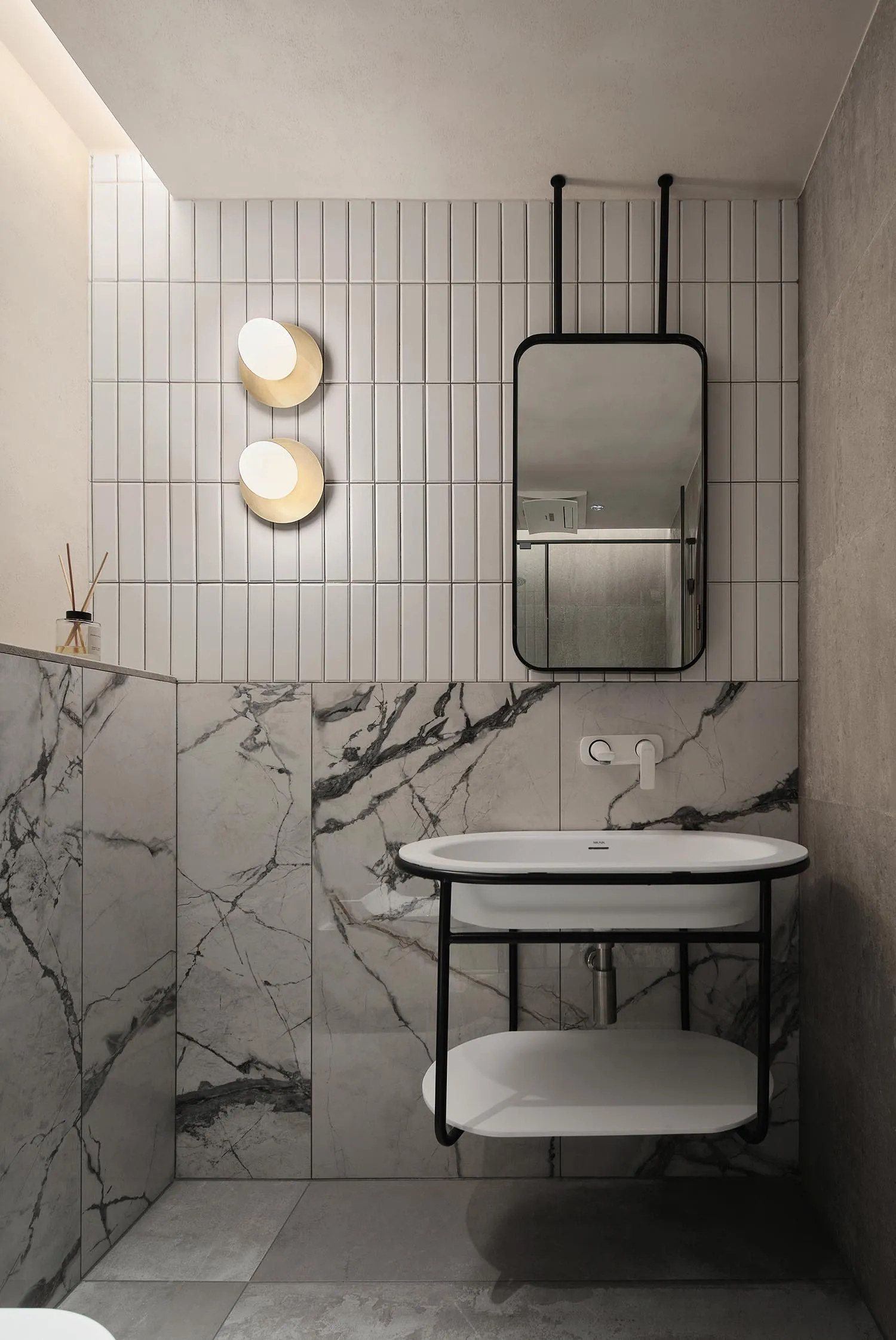 A modern bathroom with marble tiles and a floating vanity.