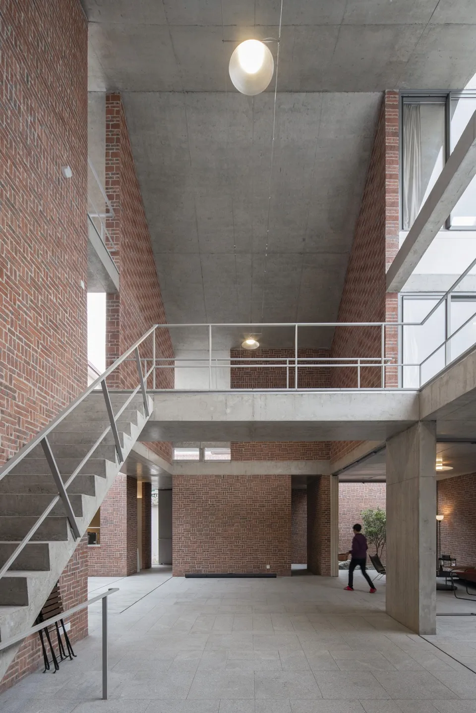 A modern interior space featuring brick and concrete walls.