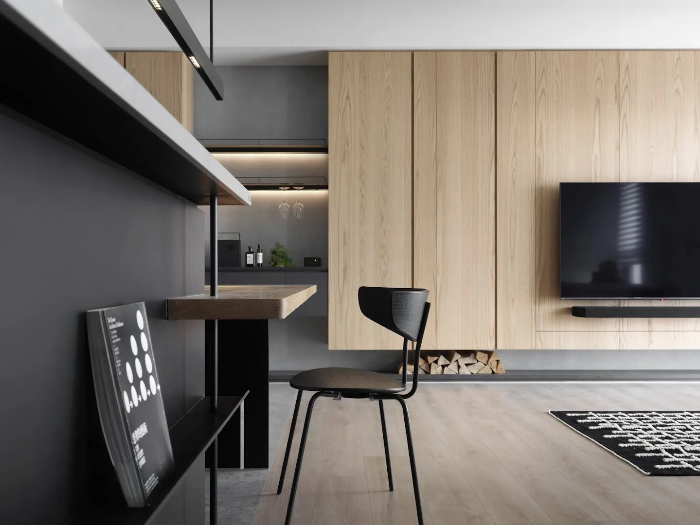 A modern minimalist living room with wood flooring, minimalist furniture, and a TV mounted on a wooden wall panel.