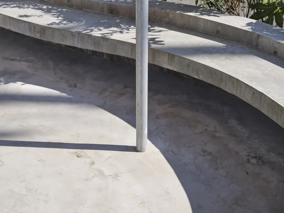Outdoor architectural ramp constructed from concrete