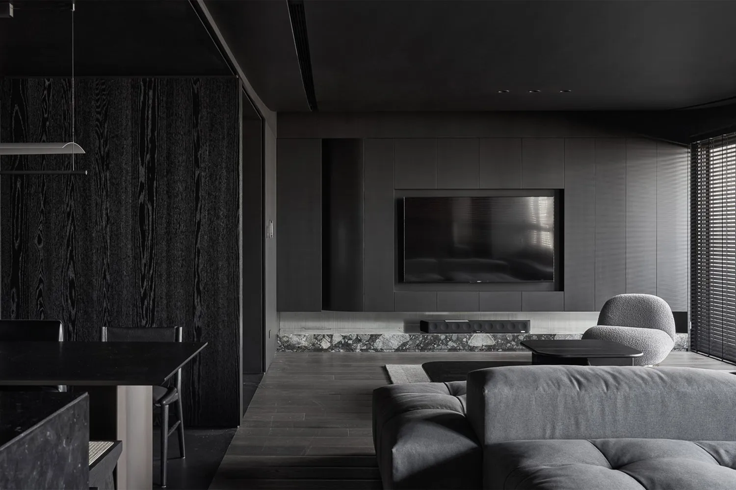 Contemporary living room with black stained wood, marble accents, and leather seating.