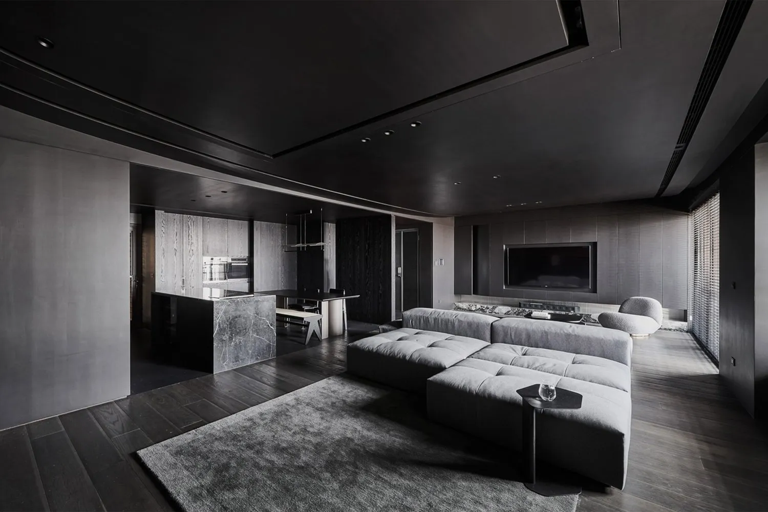 A modern living room featuring gray tones and contemporary design elements.