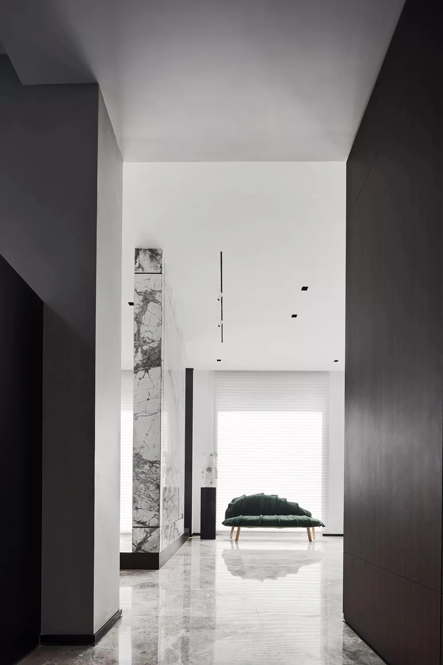 Modern minimalist living space featuring marble flooring and walls.