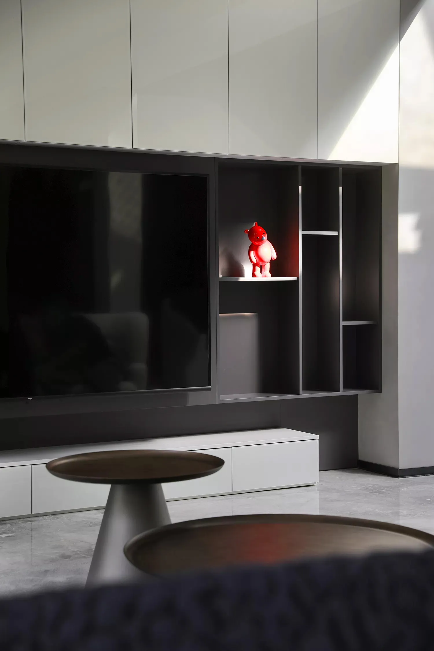 A modern living room featuring metal and glass elements.