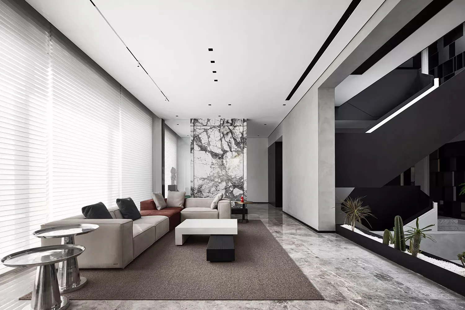 Modern minimalist living room with a gray marble floor and white furniture.