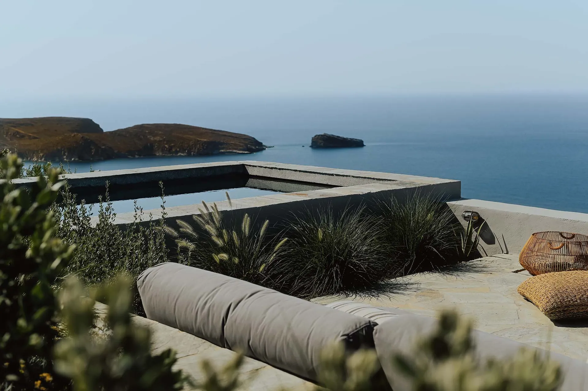 A minimalist landscape featuring concrete and glass elements.