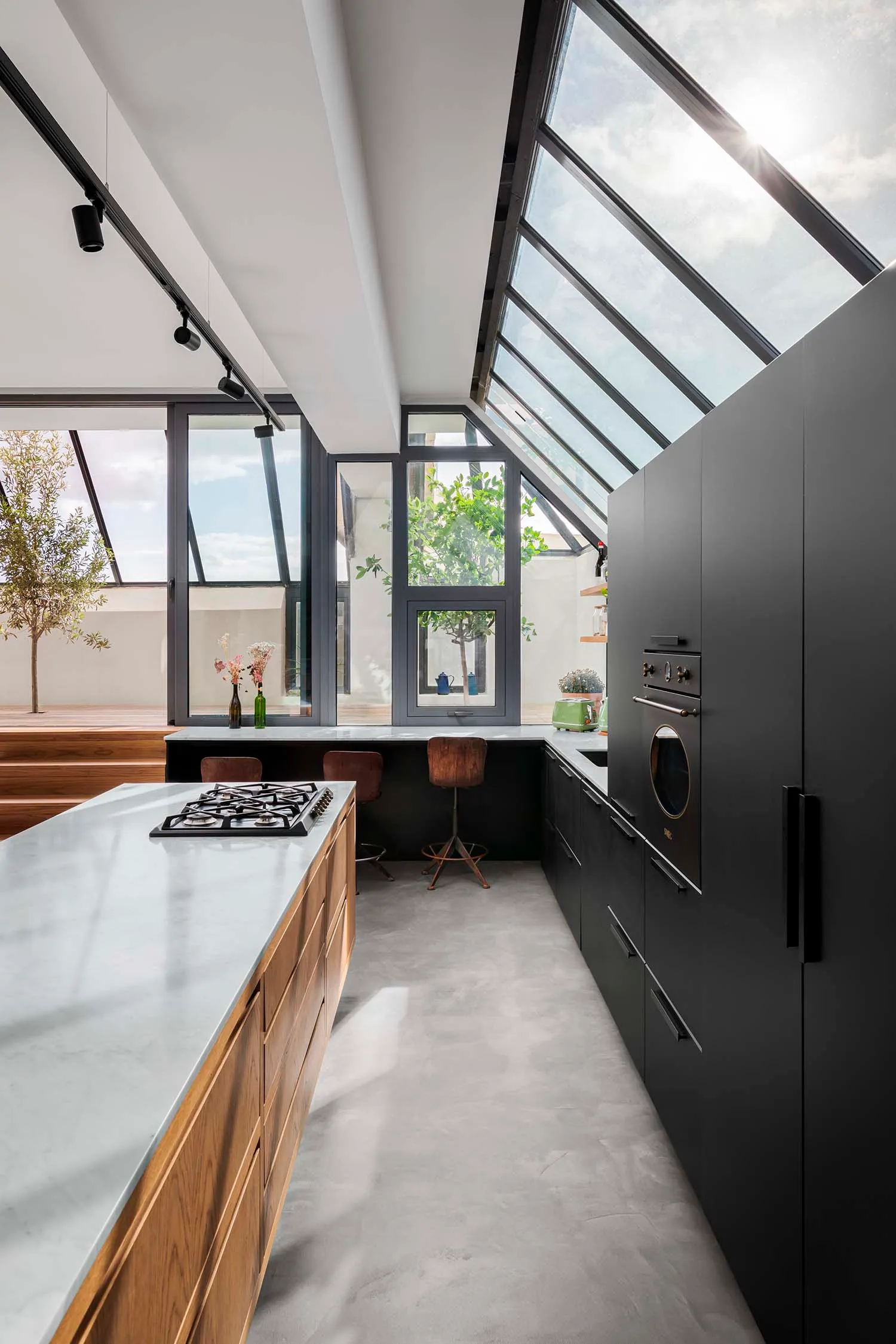 Modern residential kitchen with composite countertop and black cabinets