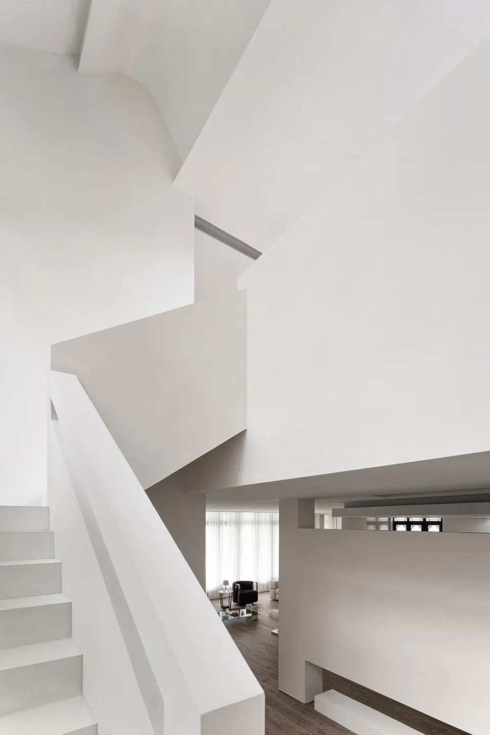 Modern interior with a staircase featuring concrete and white stone.
