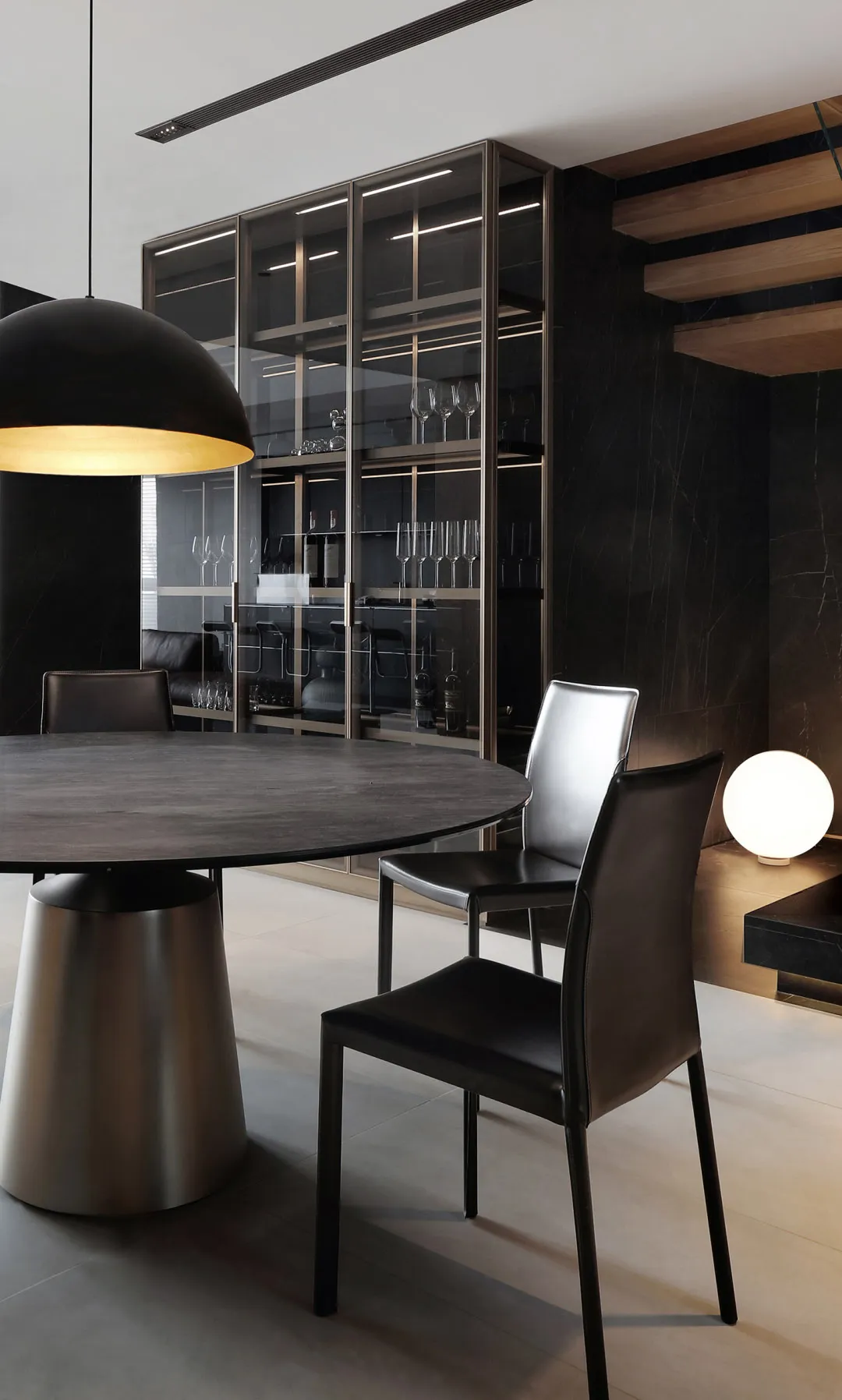 Modern dining room with marble table and leather chairs.
