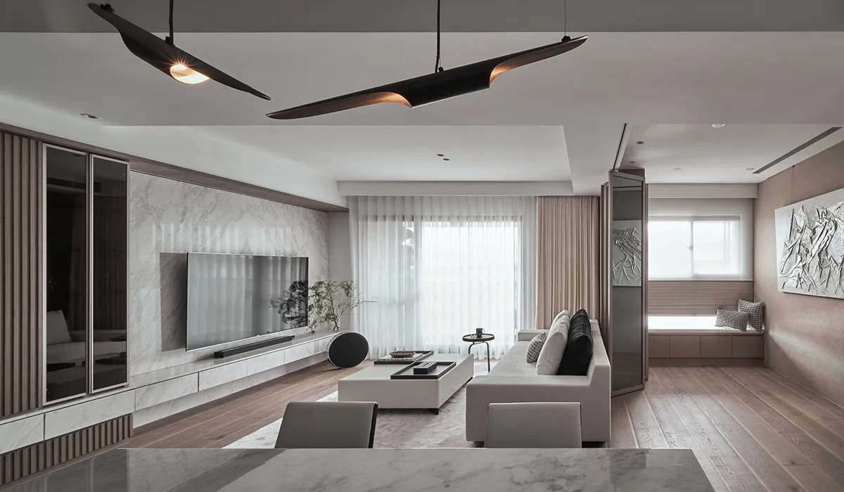 Modern living room featuring marble accents, wood flooring, and glass elements.