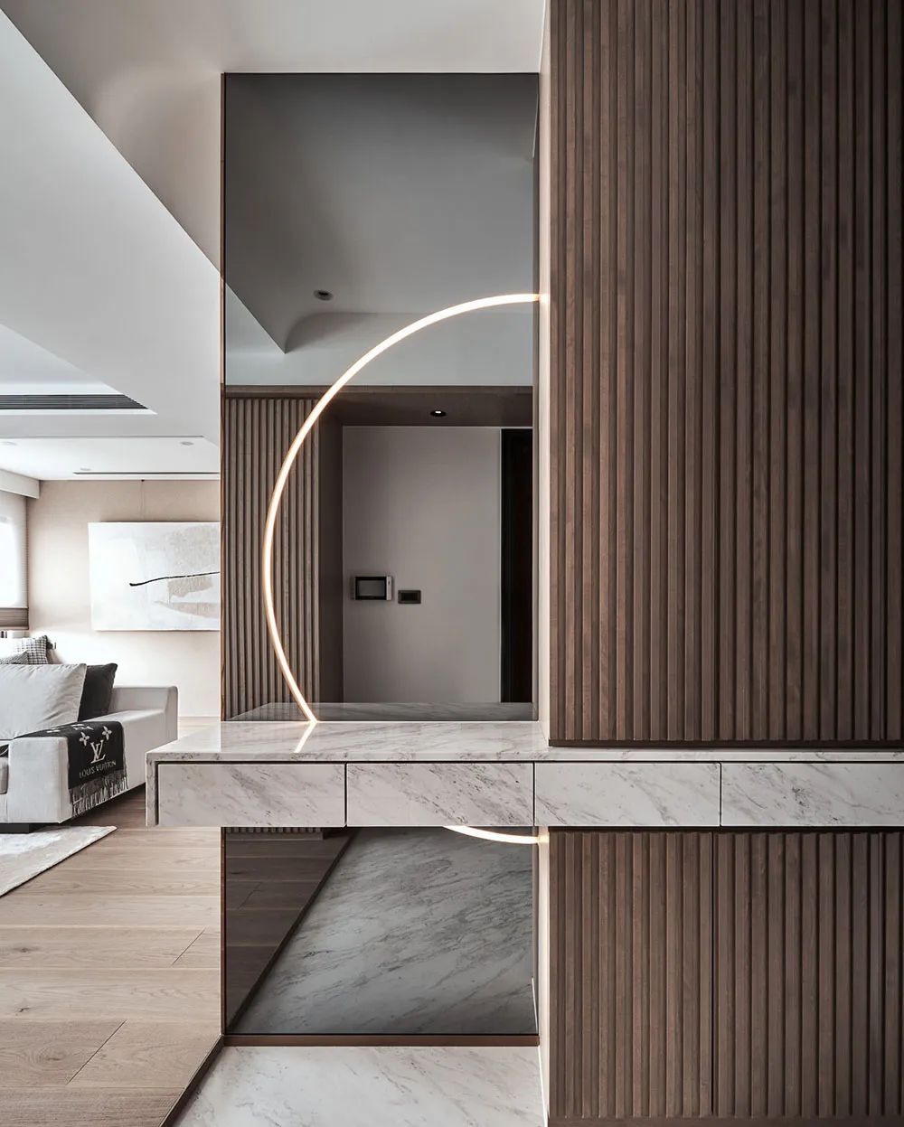 Modern living room featuring marble accents and wooden panels.