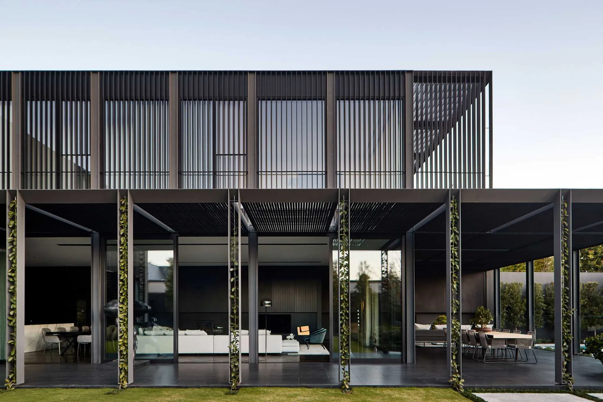 Modern building with metal overhangs, glass panels, and concrete floors.
