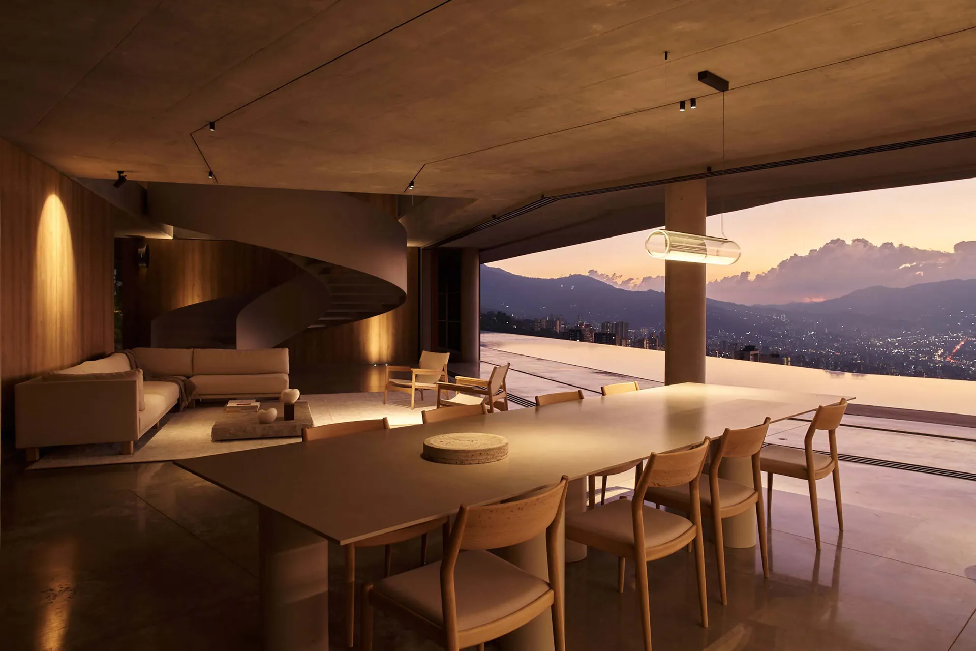 A modern, minimalist residential interior featuring a large table and chairs with a view of the cityscape.