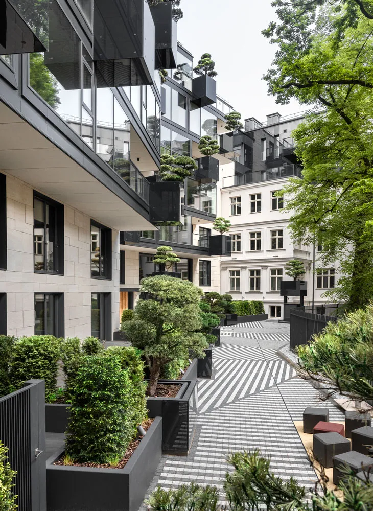 Modern residential building with concrete and glass materials, featuring minimalist design and urban architecture.