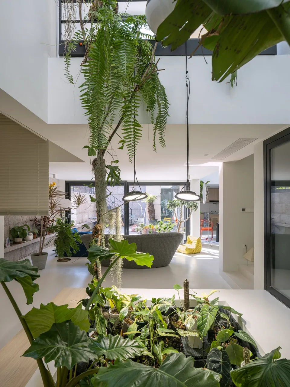 Modern, minimalist living room featuring concrete walls and floors.