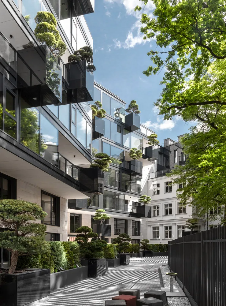Modern residential building with glass and concrete materials.