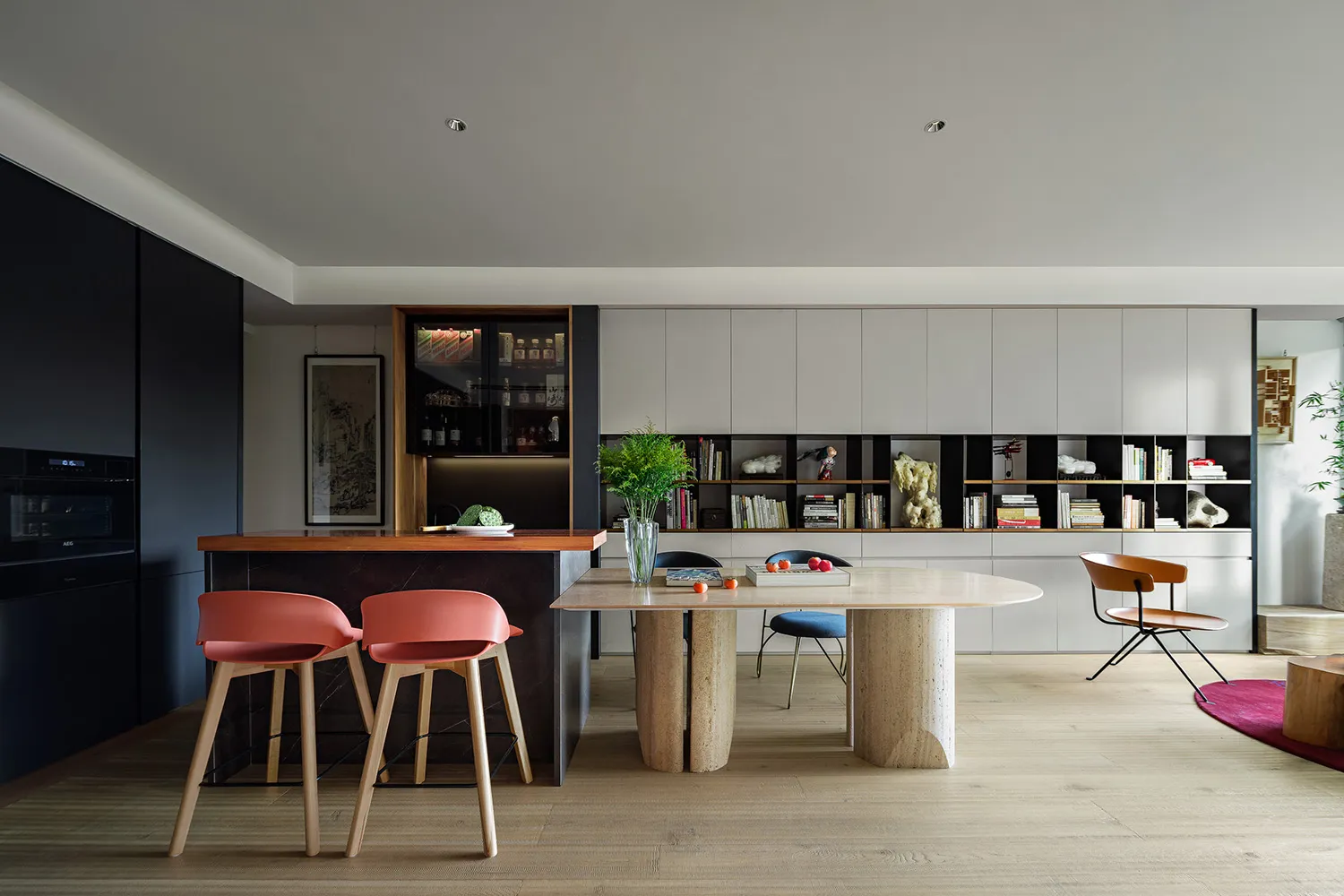 Modern kitchen with a white marble countertop and black cabinets.