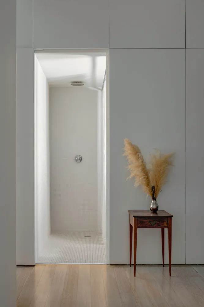Modern minimalist bathroom with white tiled walls and floor