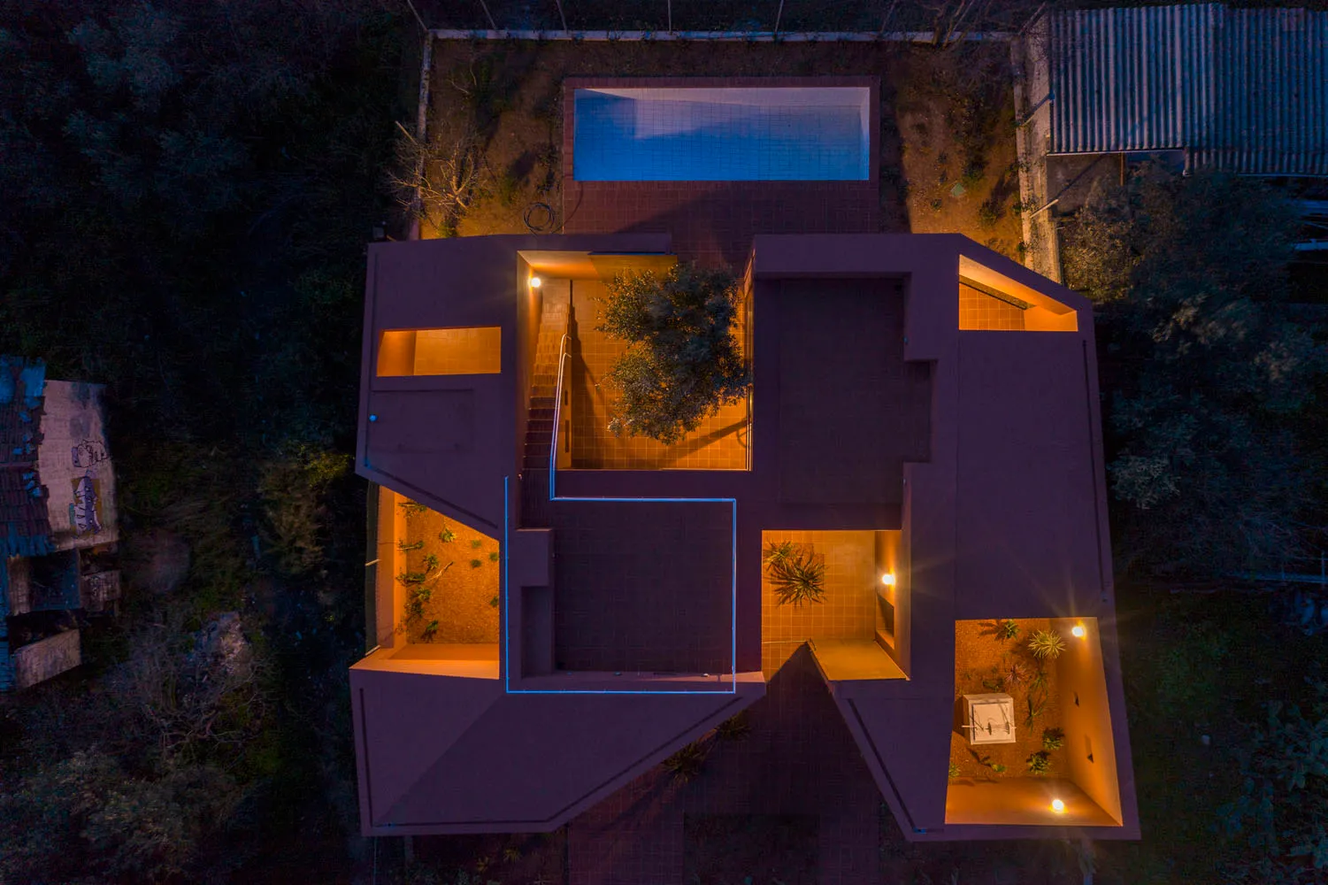Aerial view of a modern residential architecture featuring a pool, tree, and open spaces with ceramic tile flooring and stair