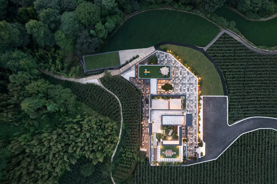 Aerial view of a modern residential building with a concrete and glass exterior.