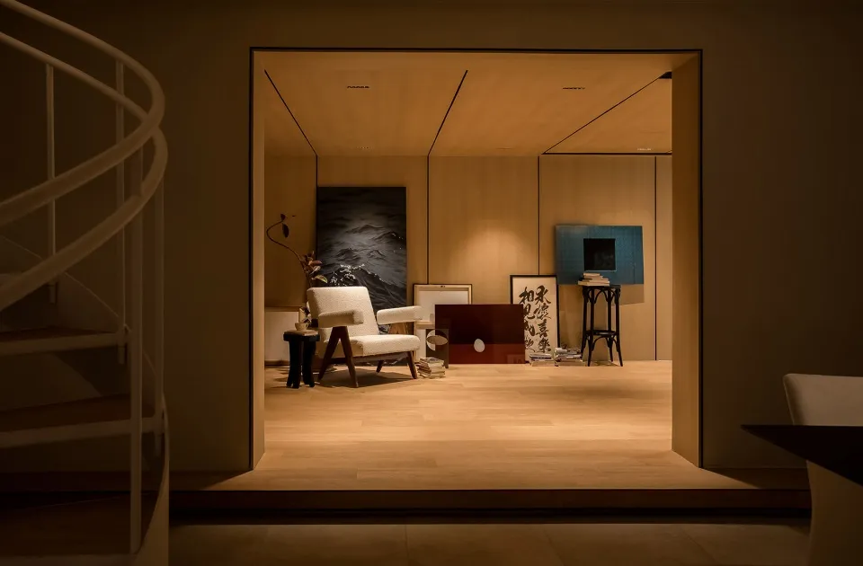 Minimalist living room with wooden furniture and a painting.