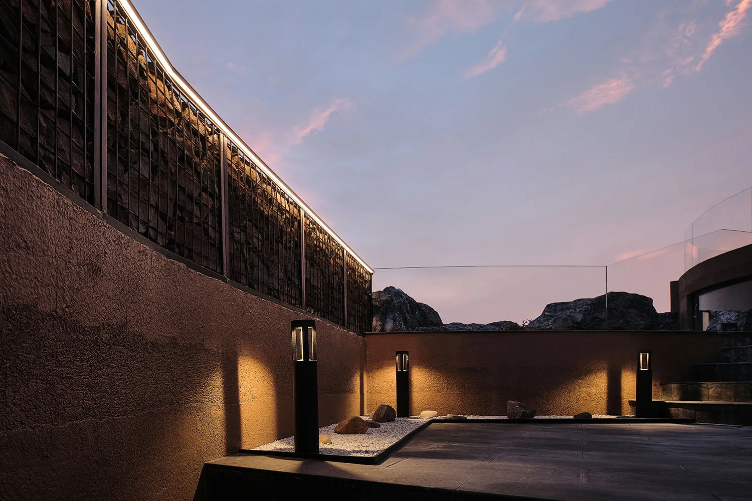 Modern rooftop garden with concrete and stone elements at dusk.
