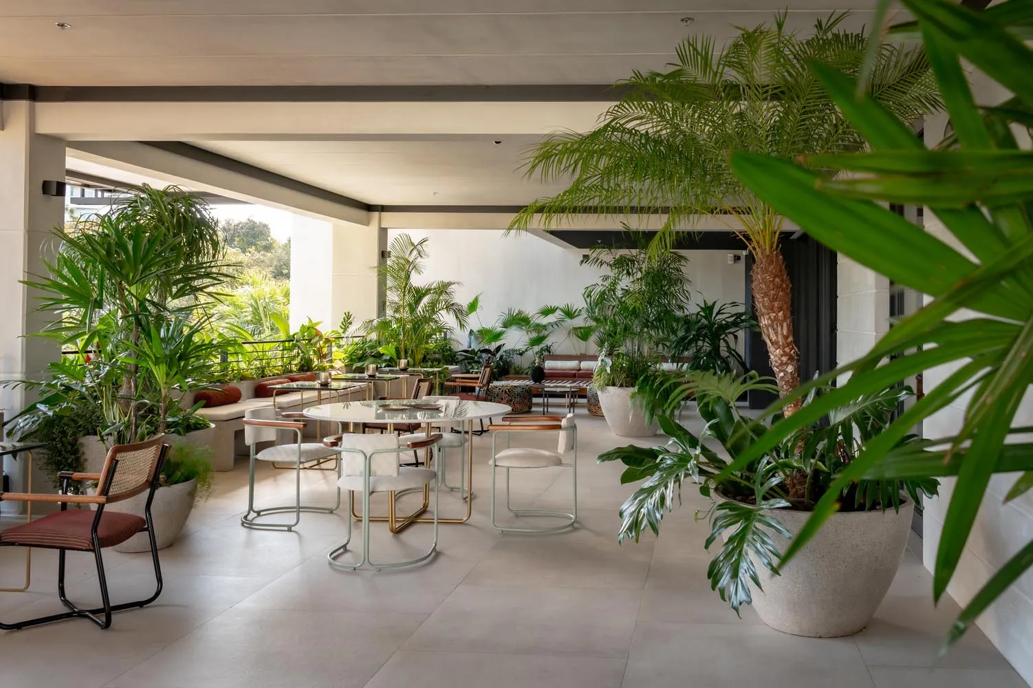 Modern living room with concrete flooring and minimalist furniture.