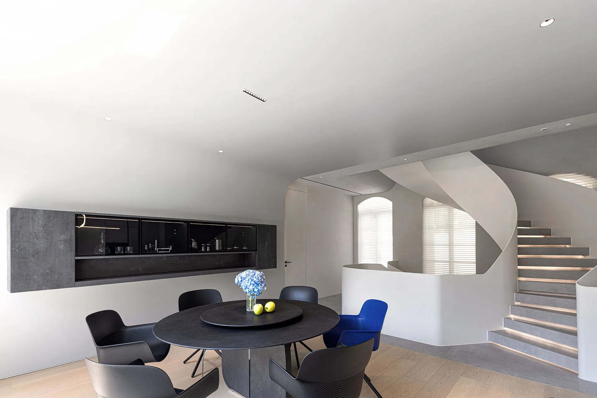 Modern interior design with concrete elements and minimalist furniture.