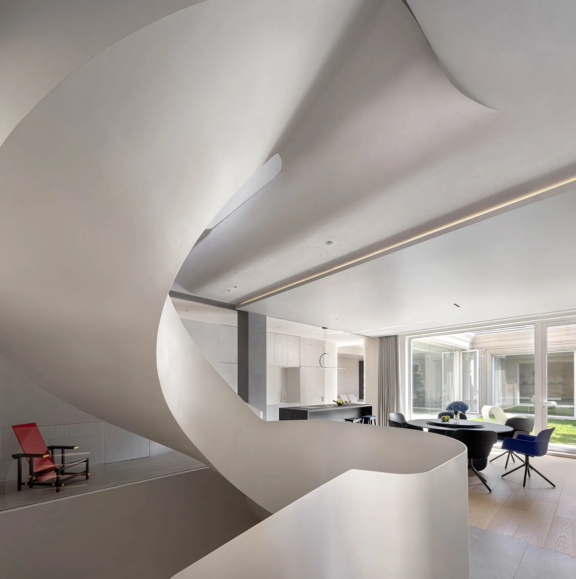 A modern residential interior featuring a white concrete staircase with a sleek and minimalist design.