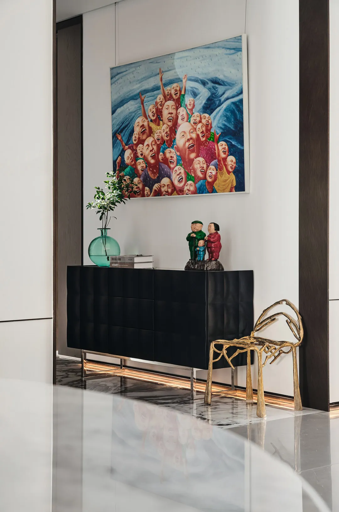 Modern lounge area with metal, glass, and wooden furnishings and decorative elements.