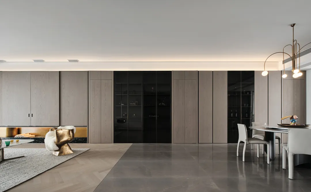 Modern minimalist living room with marble floor, wooden furnishings, and metal accents.