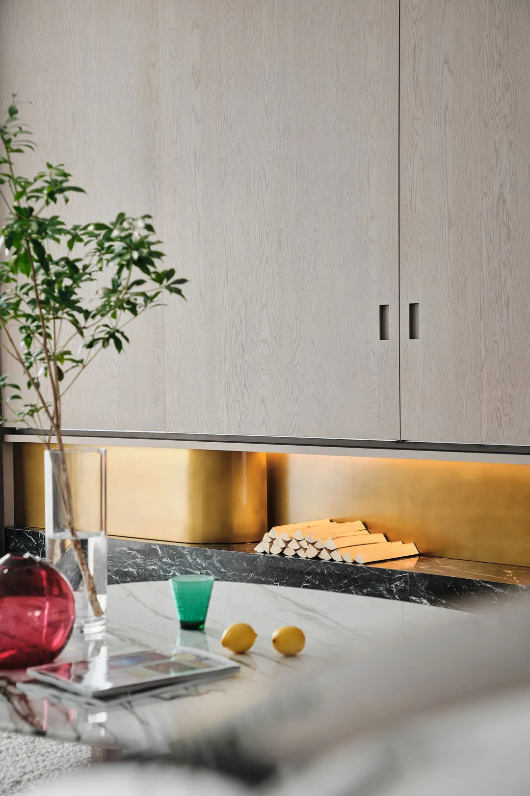 Modern kitchen interior featuring marble countertops and wooden cabinets.