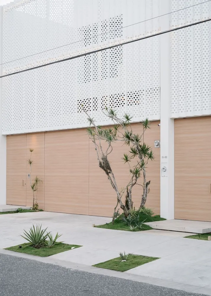 Modern residential exterior with garage doors and minimalist design elements.