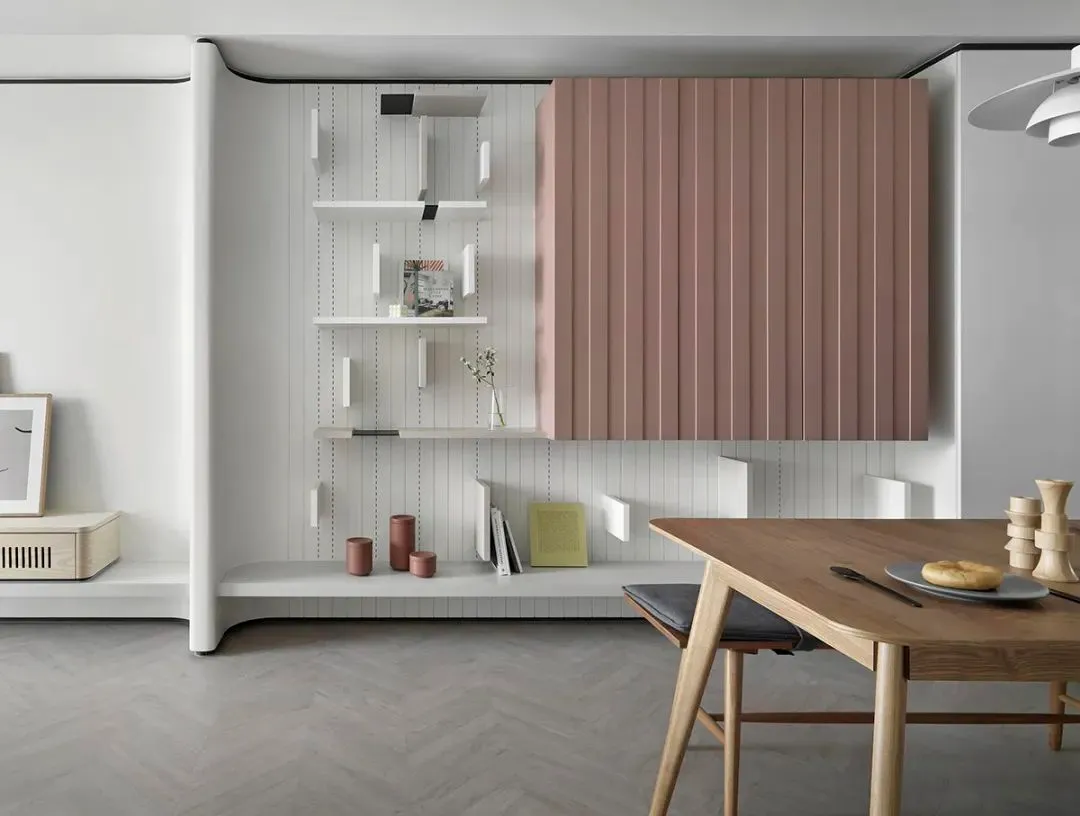 Minimalist interior design featuring wooden furniture and laminate flooring.