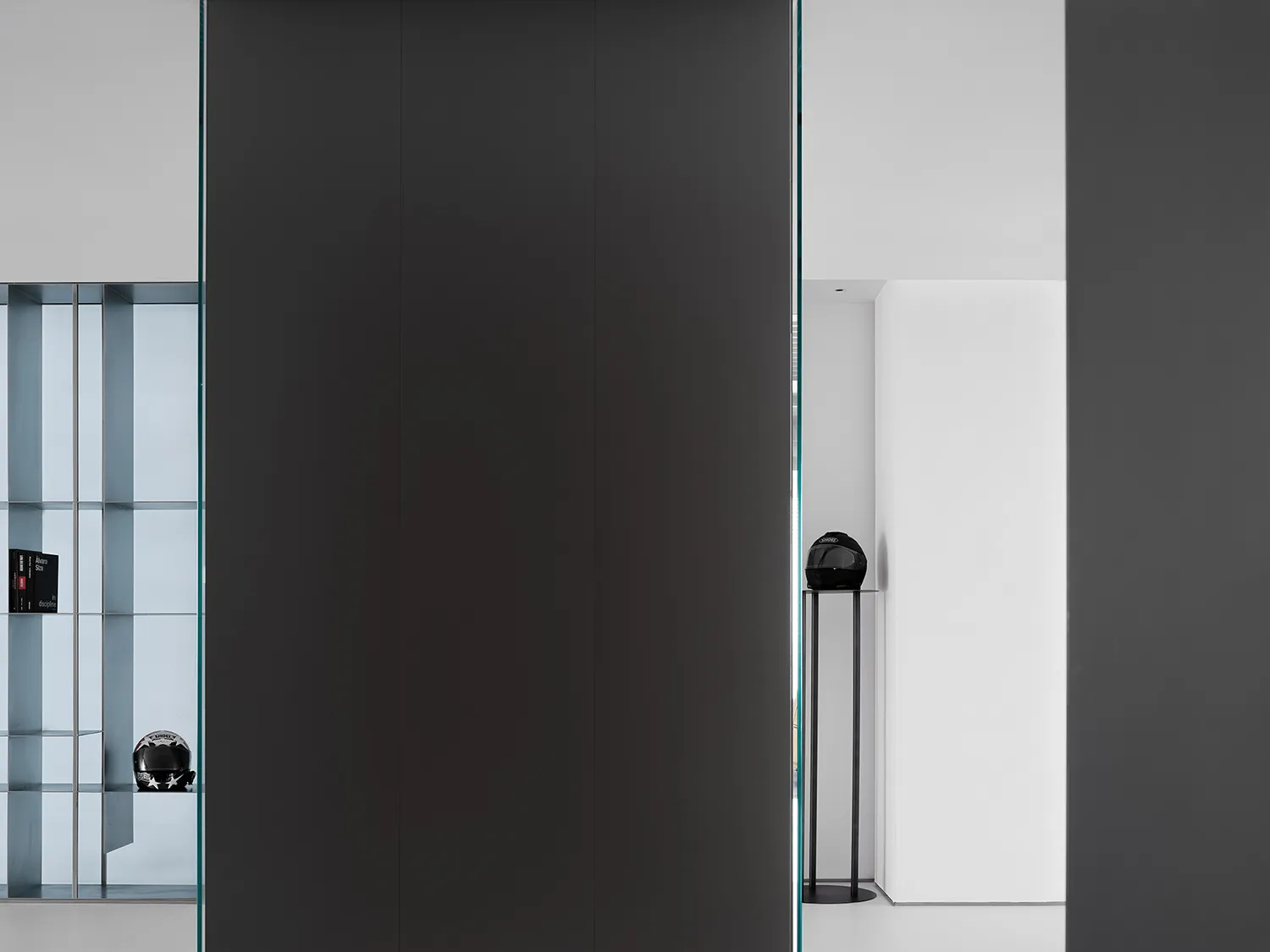 Interior design featuring a minimalist office space with black metal accents.