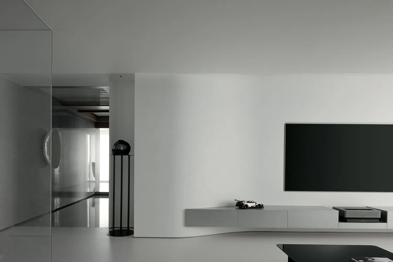Minimalist modern reader sitting area with concrete floor and glass elements.