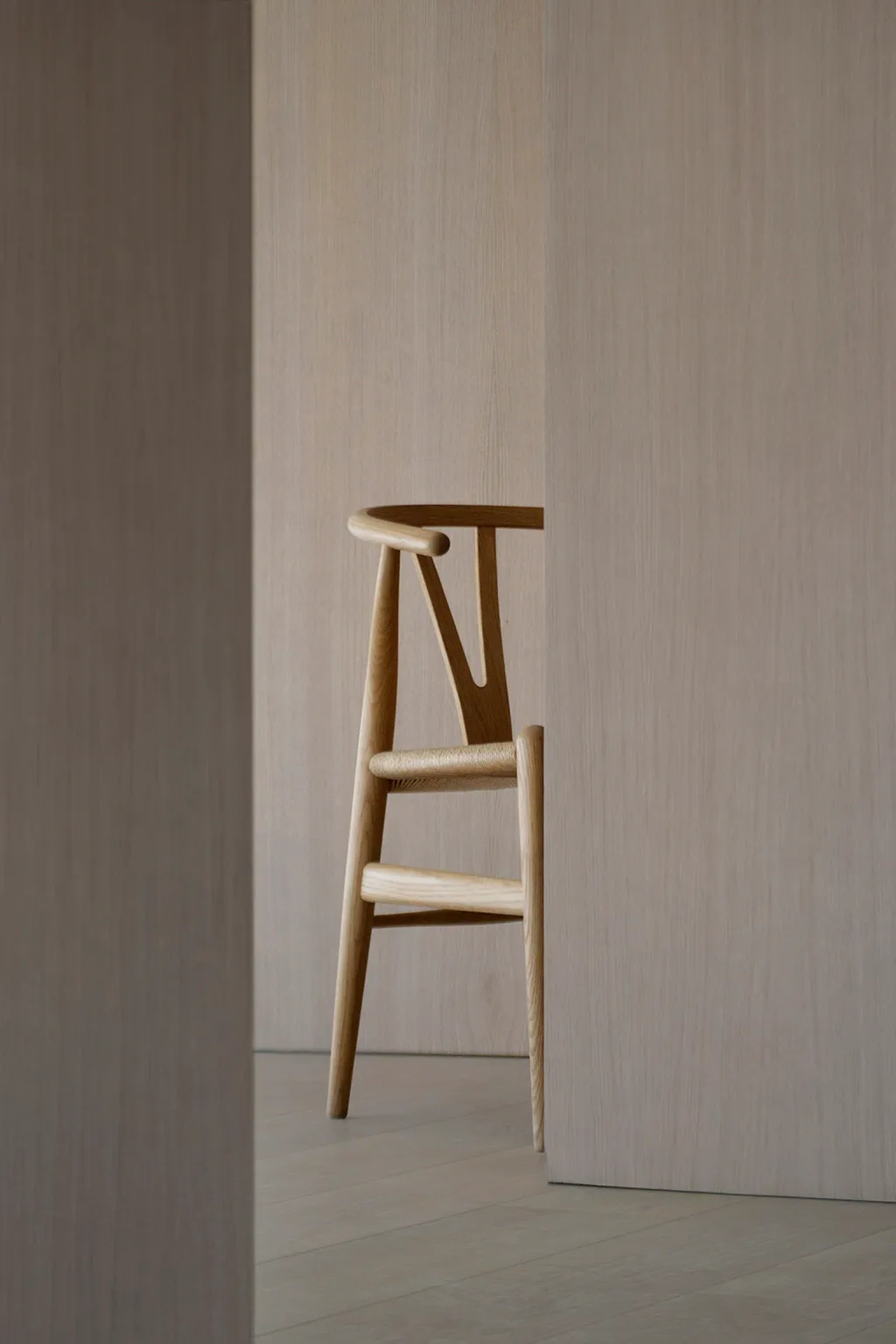 Modern wooden bar chair against neutral background