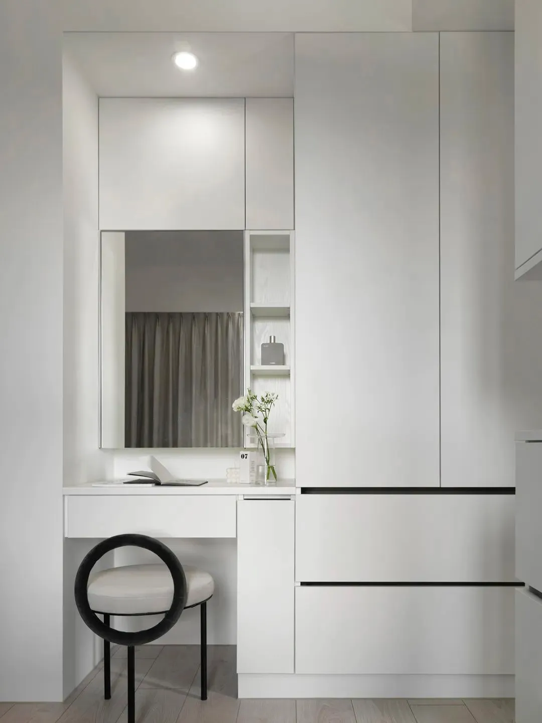 Modern interior design featuring minimalist white cabinets and ceramic tile flooring.